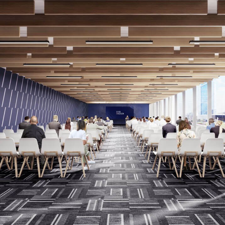Large carpeted event space with chairs and slatted wood ceiling